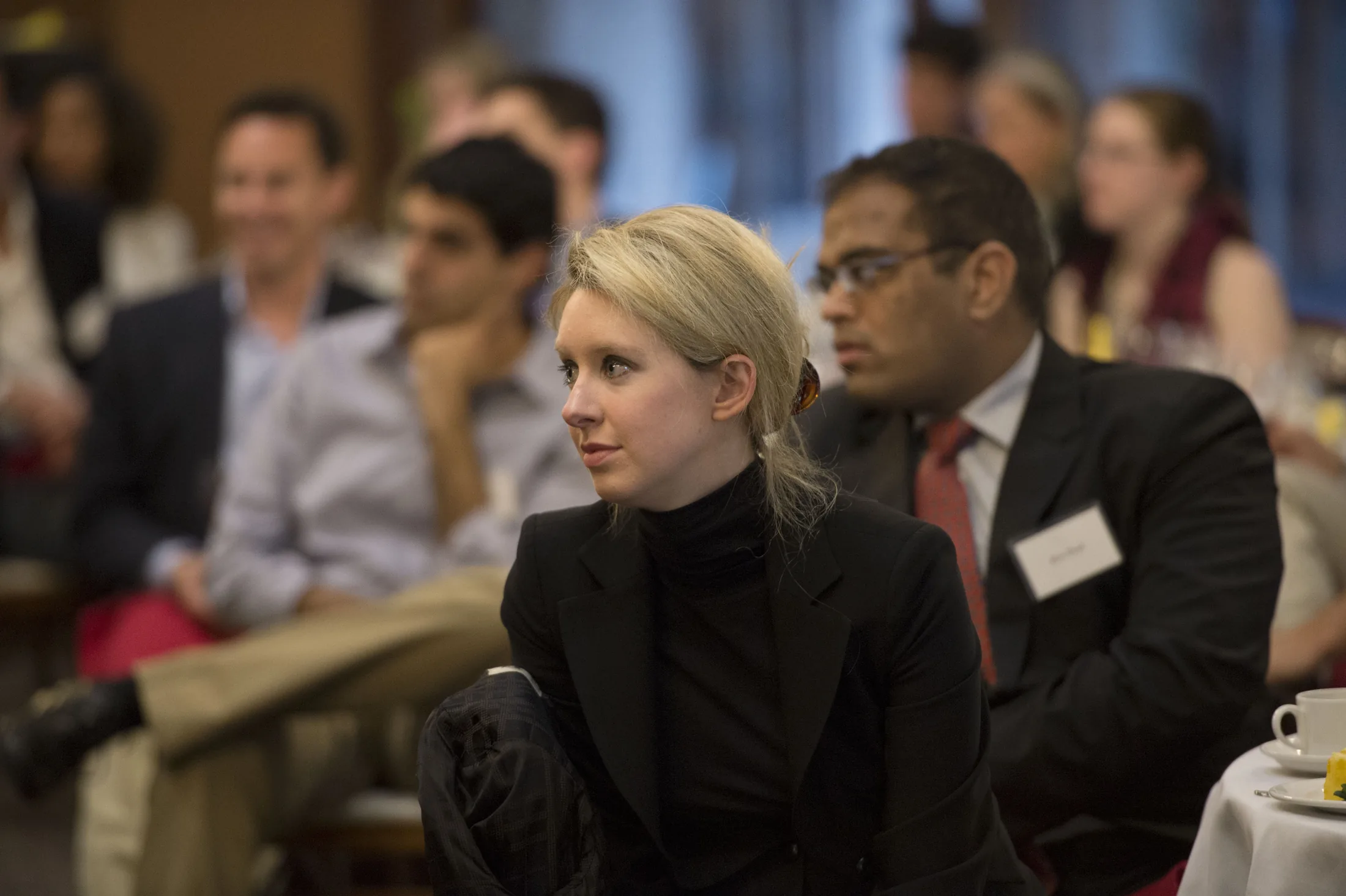 Elizabeth Holmes, the chief executive officer and founder of Theranos, a health care technology company, listens as Deputy Secretary of Defense Ash Carter speaks at Stanford University in Palo Alto, Calif., April 17, 2013. (DoD photo by Gle