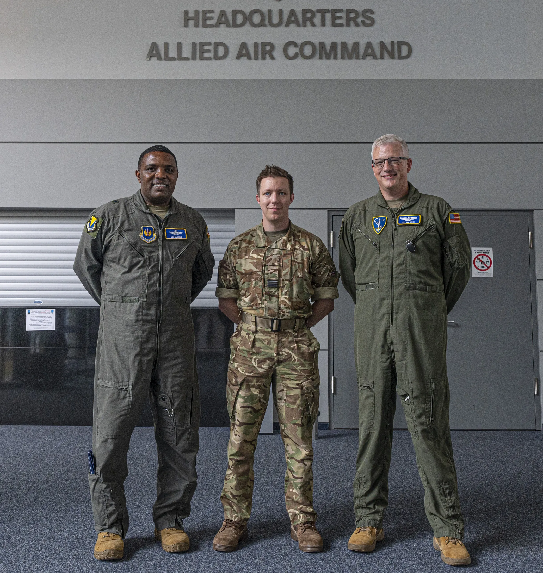 Royal Air Force Flight Lt. Benjamin Northwood, NATO Allied Air Command joint exercise planner, poses for a photo with U.S. Air Force Brig. Gen. Otis C. Jones, 86th Airlift Wing commander and U.S. Air Force Col. Edwin Markie, NATO AIRCOM dir