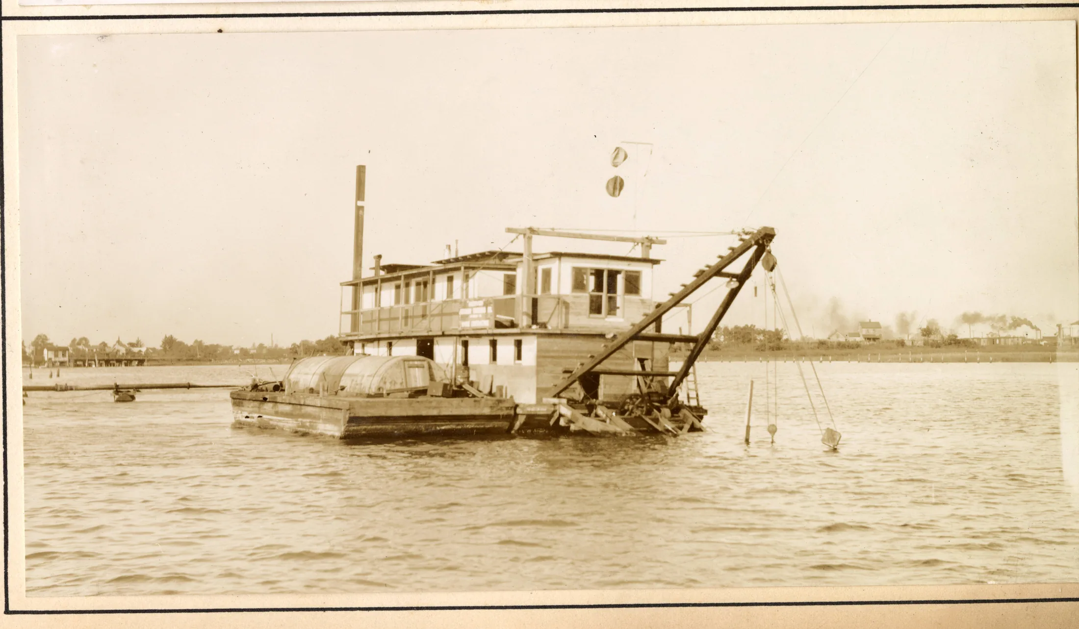 Dredge Northwood owned by Atkinson Dredge Co. dredging Scotts Creek. [Image of dredge on the water.]