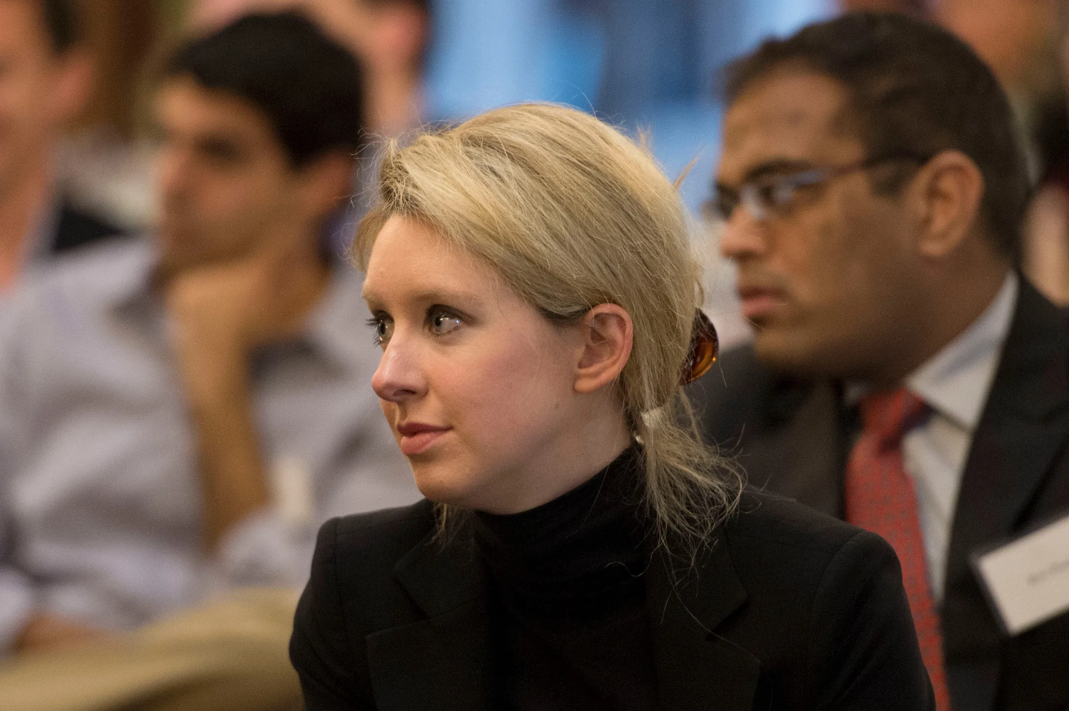 Elizabeth Holmes, the chief executive officer and founder of Theranos, a health care technology company, listens as Deputy Secretary of Defense Ash Carter speaks at Stanford University in Palo Alto, Calif., April 17, 2013. (DoD photo by Gle