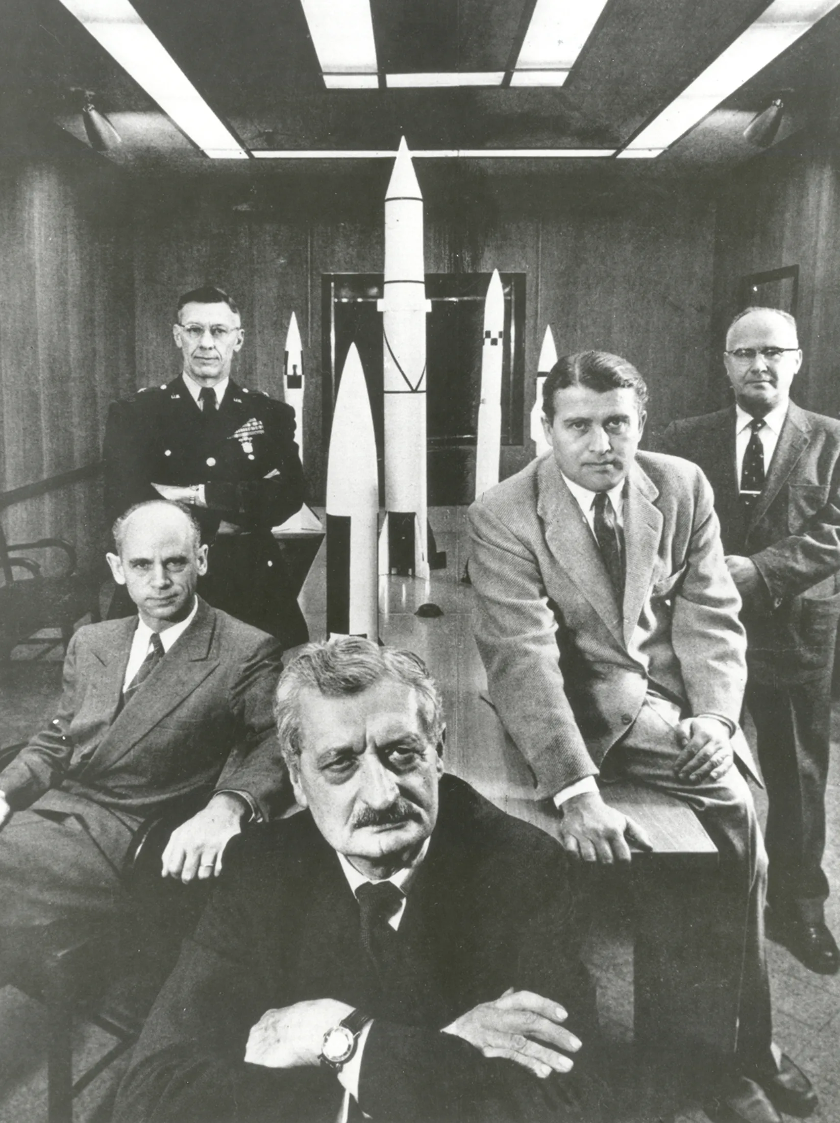 Hermann Oberth (forefront) with officials of the Army Ballistic Missile Agency at Huntsville, Alabama in 1956. Left to right around Oberth: 1) Dr. Ernst Stuhlinger (seated). 2) Major General H.N. Toftoy, Commanding Officer and person respon