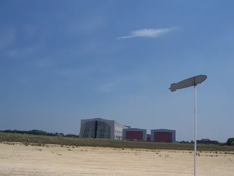 Marker commemorating the Hindenburg disaster of May 6, 1937, in Lakehurst, New Jersey. Hangar No. 1 is in the background.