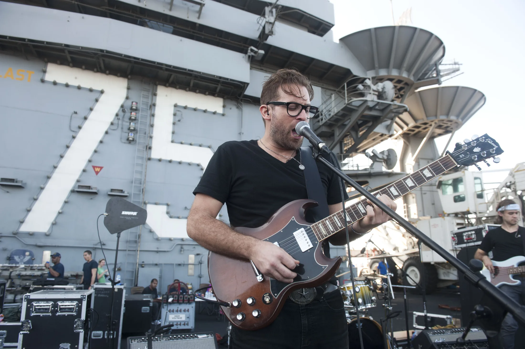 GULF OF OMAN (Dec. 15, 2013) Matthew "Truck" Roley, of country band Mockingbird Sun, performs for the crew on the flight deck of the aircraft carrier USS Harry S. Truman (CVN 75) as part of a Navy Entertainment tour. Harry S. Truman, flagsh